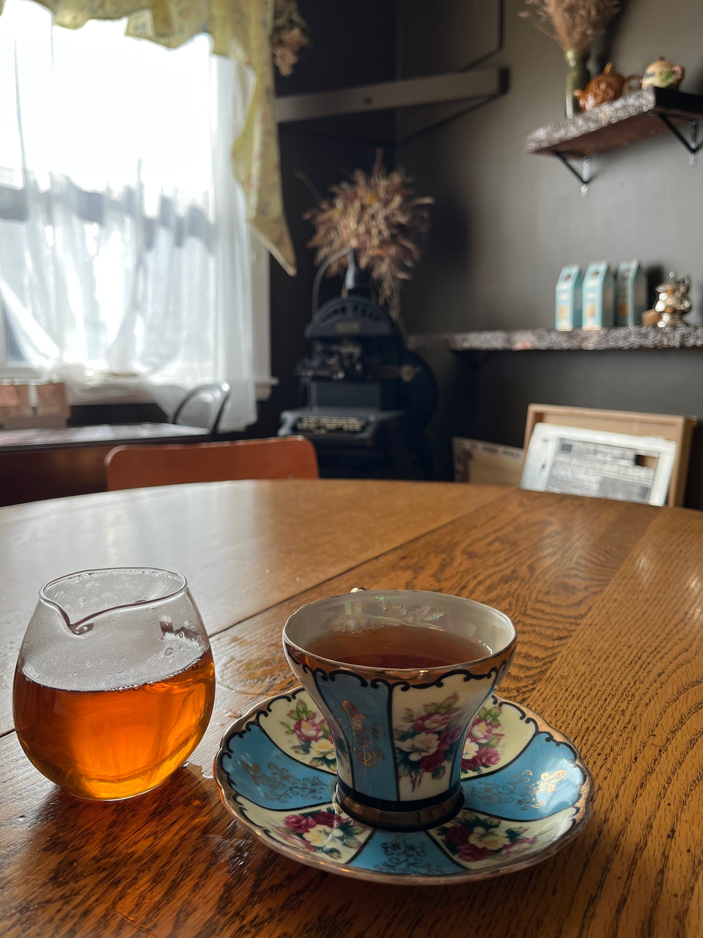 Decorative teacup with floral design on a wooden surface