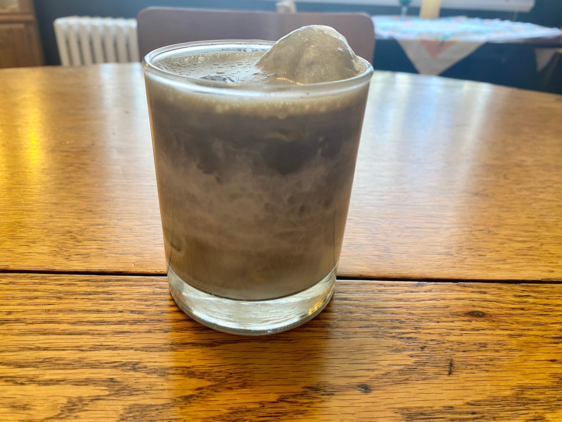 Iced hojicha latte inside a glass cup.